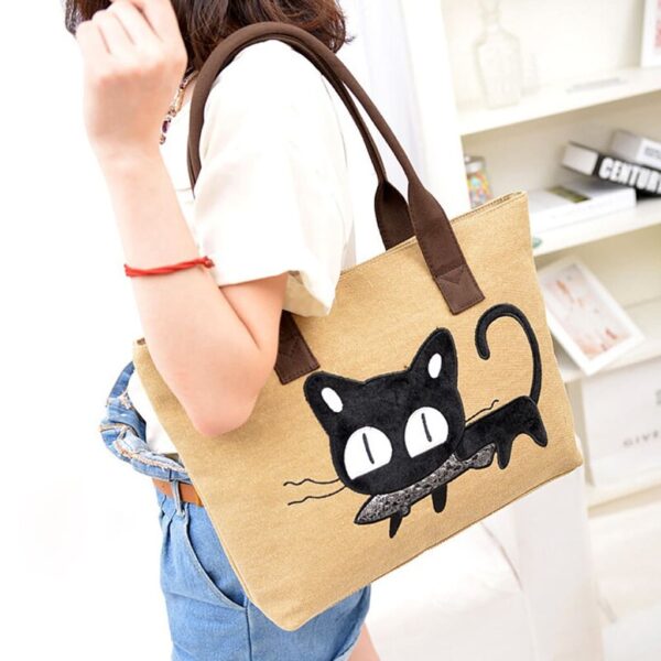 girl carrying beige beau moe cat tote bag