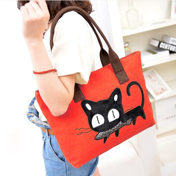 girl carrying red beau moe cat tote bag