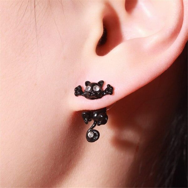 girl wearing black jack cat earrings
